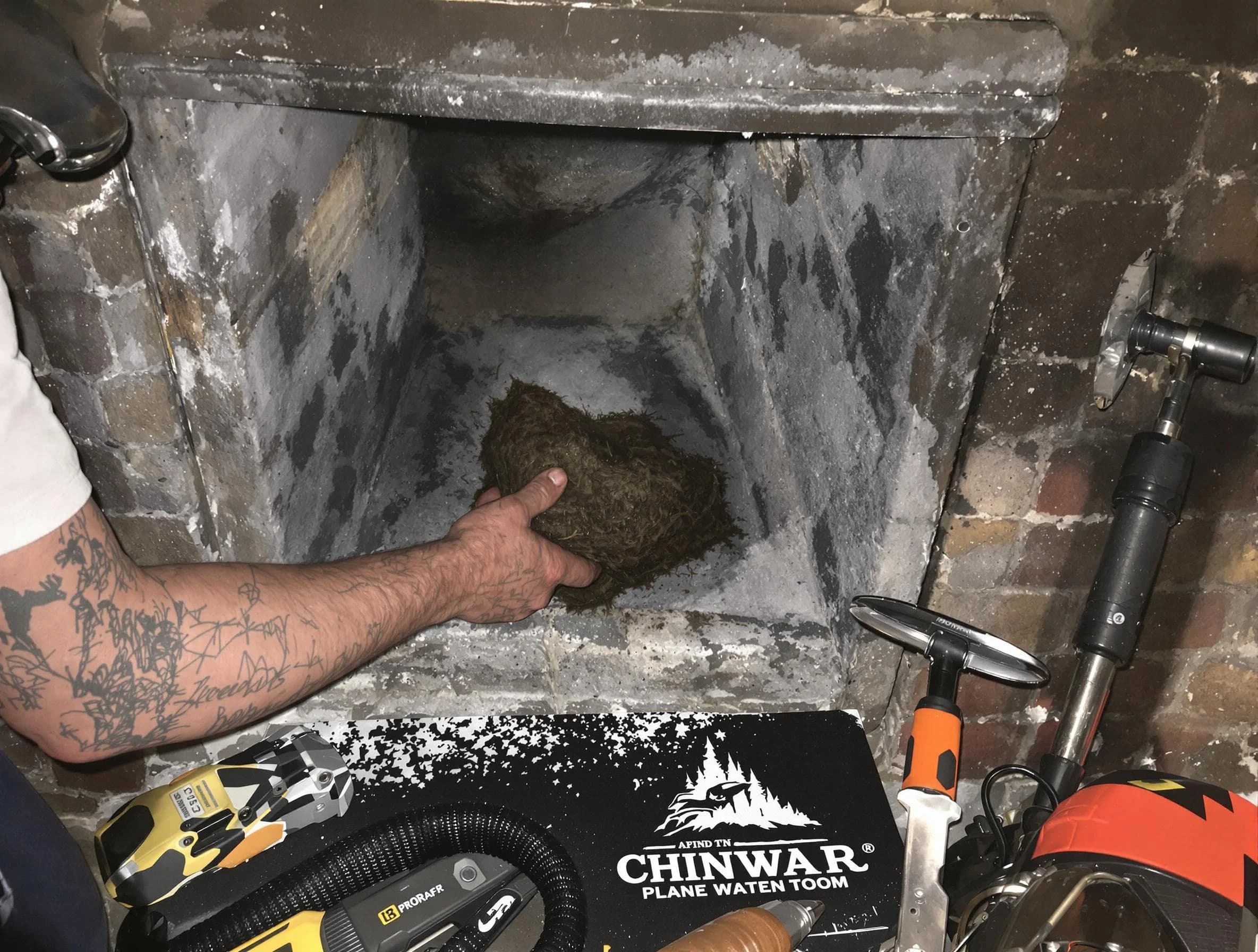 Newton Chimney Sweep safely removing debris and screening chimney in Newton, MA